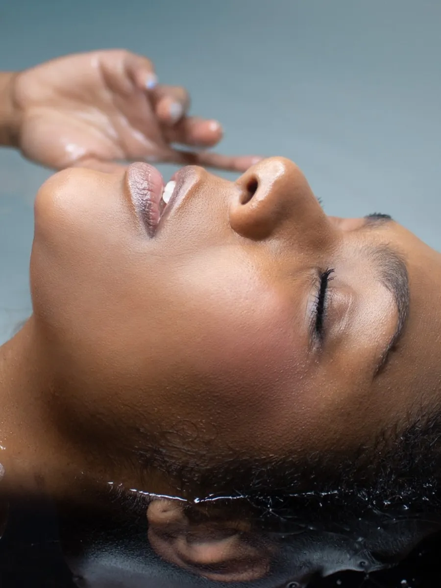 Guest floating weightlessly in warm salt water at JaxZen