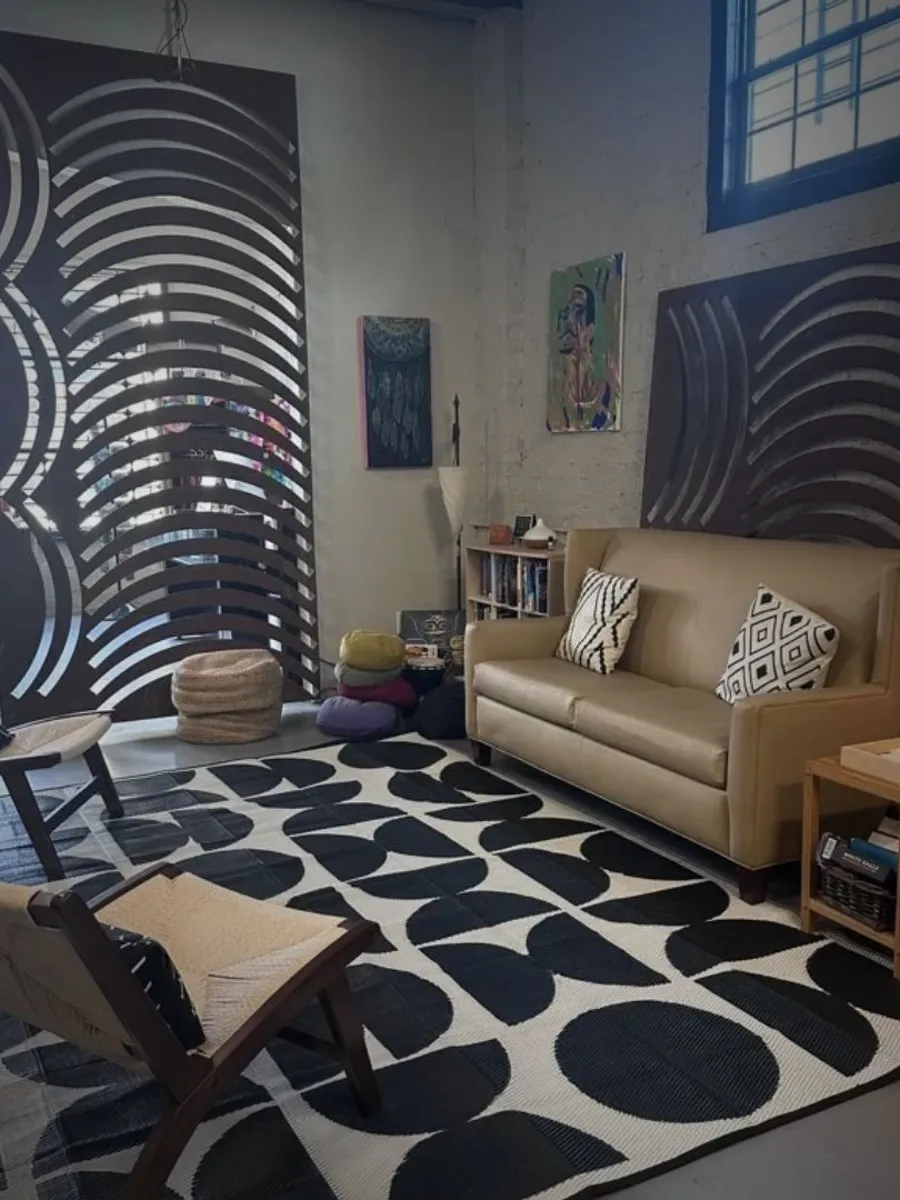 The JaxZen lounge with a couch, chairs, and wall art